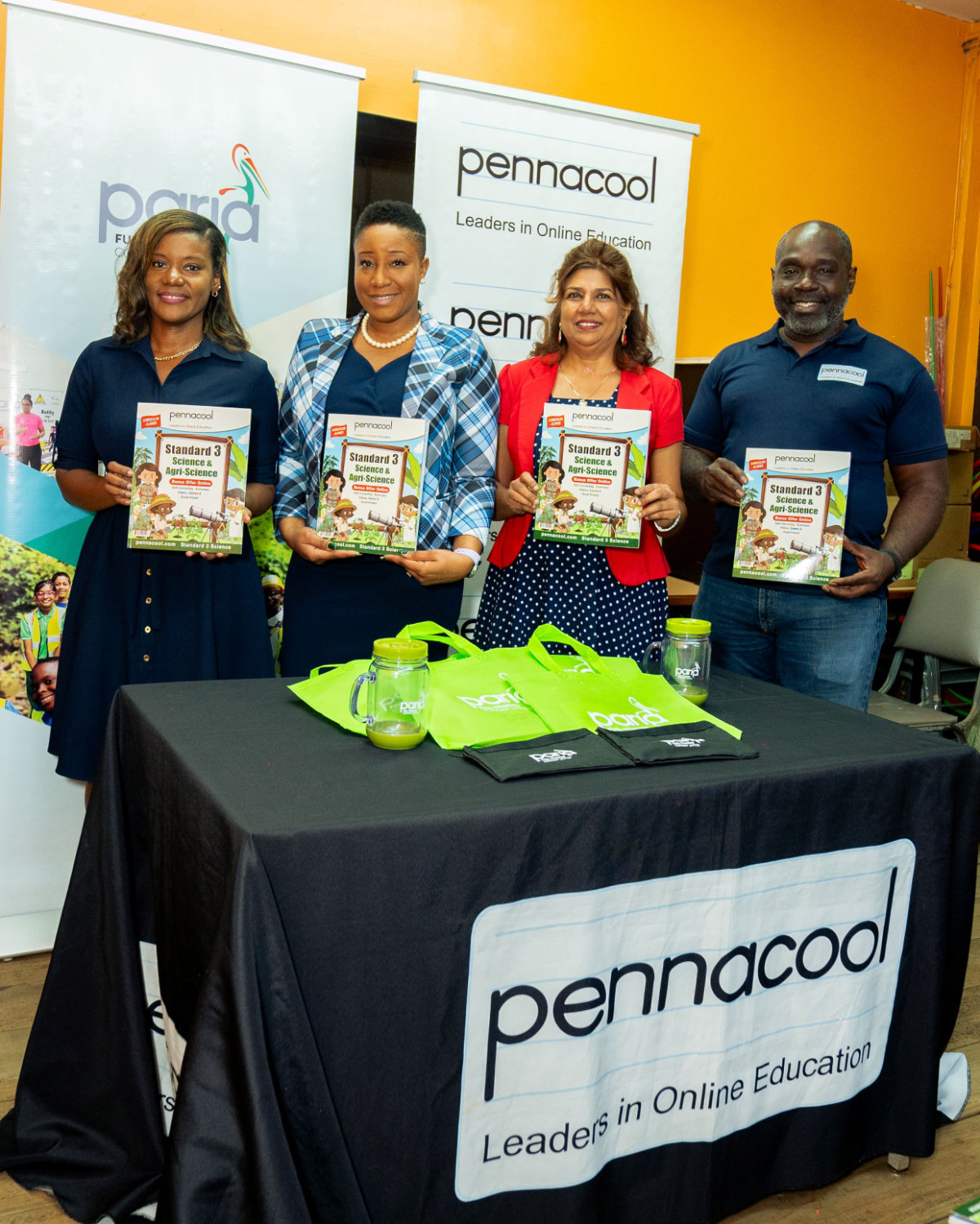 Management team from Paria and Pennacool showing the agri-science books to be donated to their fenceline community school students